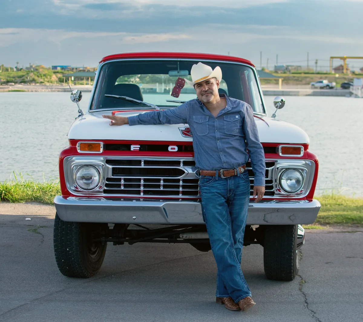 Tony Gomez, founder of Sarge, leaning on his vintage red Ford pickup